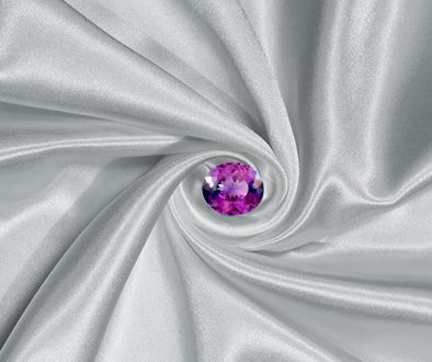 A rare and exquisite taaffeite gemstone displayed in a clean, neutral setting. The stone is faceted in a classic oval or cushion cut, revealing exceptional brilliance and clarity.