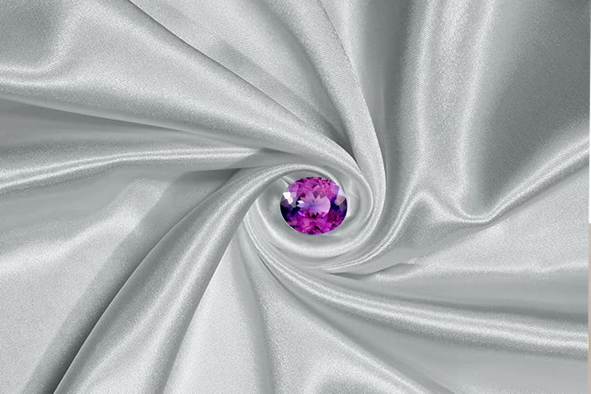 A rare and exquisite taaffeite gemstone displayed in a clean, neutral setting. The stone is faceted in a classic oval or cushion cut, revealing exceptional brilliance and clarity.